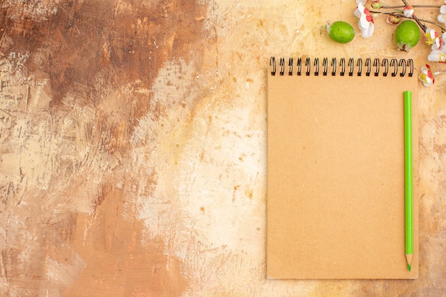 Free photo top view open notepad with feijoas and flowers