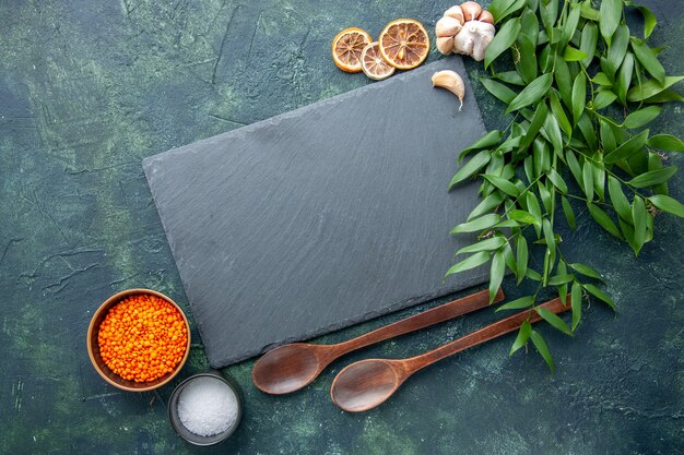 Top view orange lentils with garlic and salt on a dark blue background photo food spicy hot pepper color sharp seed soup