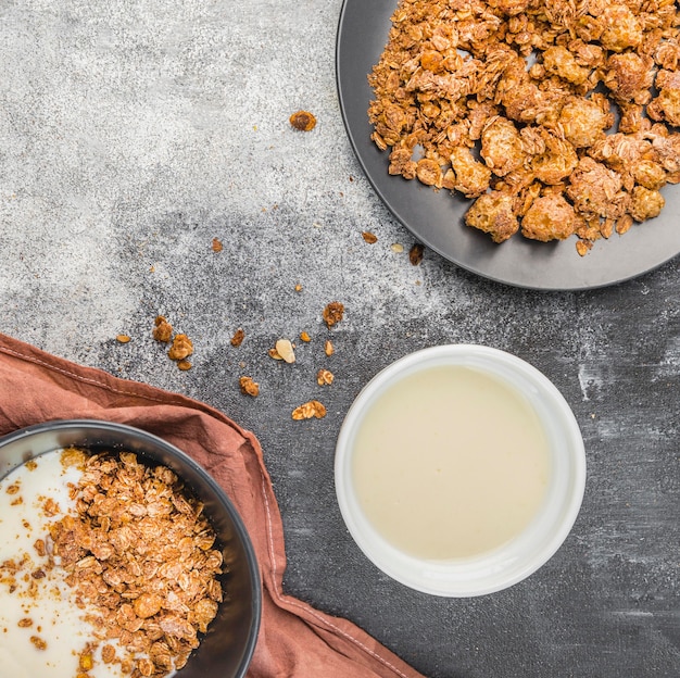 Free Photo top view organic milk with granola on the table