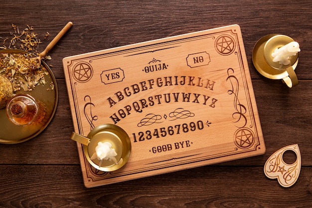 Top view ouija board and cake