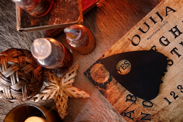 Free photo top view ouija board and small bottles