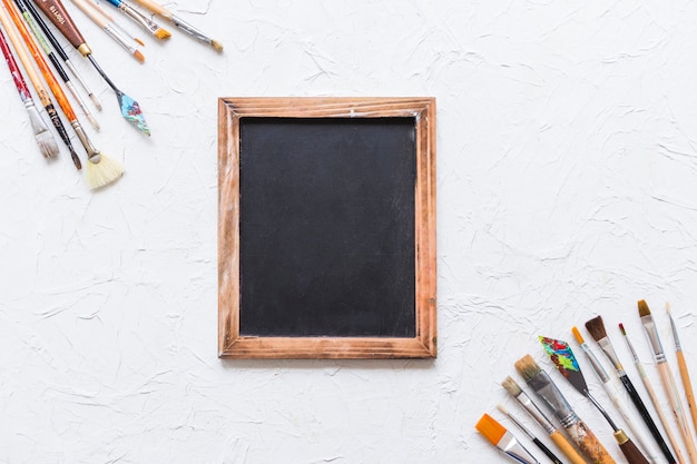 Top view paint brush corners with blackboard