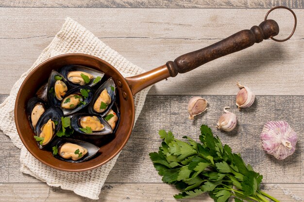 Top view pan with mussels and parsley