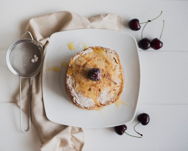 Top view pancakes with cherries 