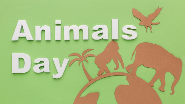 Free photo top view of paper animals with planet for animal day