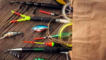 Free photo top view of paper bag with fishing essentials