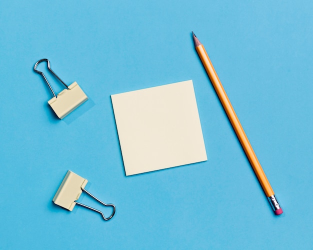 Free photo top view paper clips and pencil on the desk