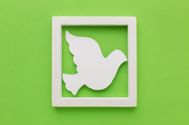 Free Photo top view of paper dove in frame