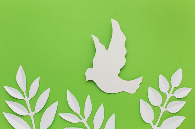 Free photo top view of paper dove and leaves