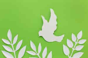 Free photo top view of paper dove and leaves