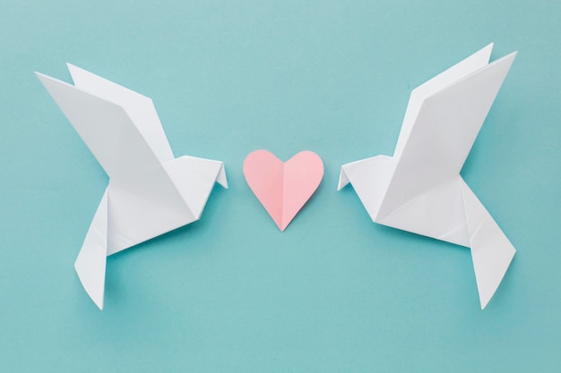 Free photo top view of paper doves with heart