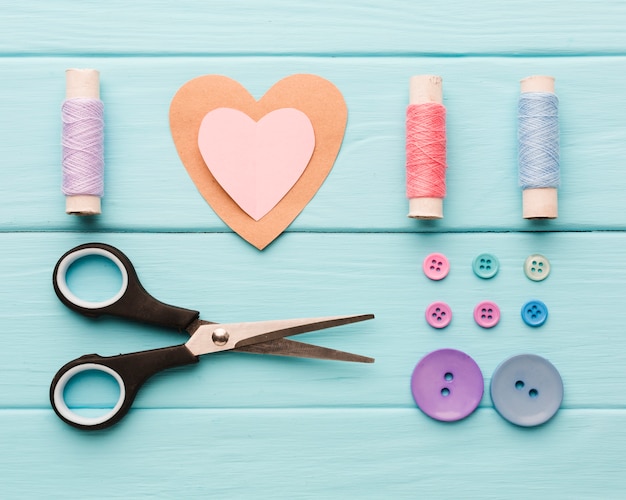 Free Photo top view of paper heart with sewing supplies for valentines day