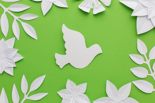 Free photo top view of paper leaves and dove