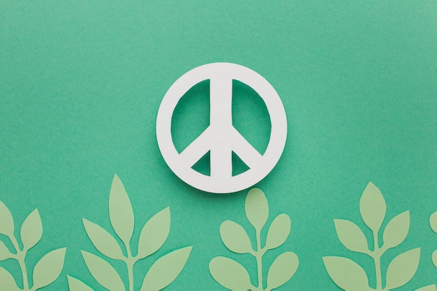 Free photo top view of paper leaves with peace sign