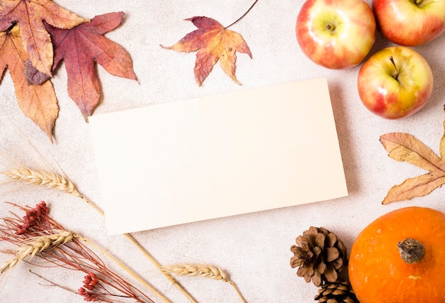 Free Photo top view of paper with apples and autumn leaves