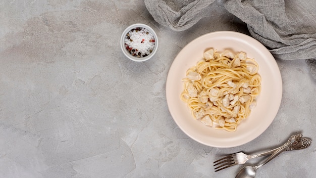 Top view of pasta on plain background with copy space