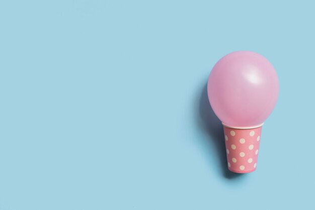 Top view pastel color balloon inside paper cup