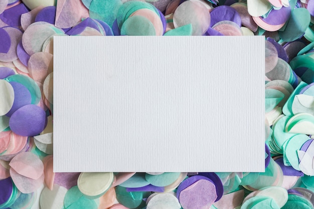 Free Photo top view pastel color confetti with paper in the middle