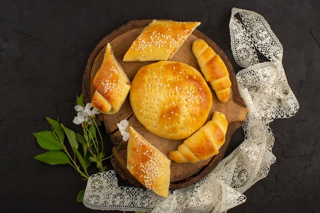 top view pastries along with croissants sweet yummy delicious on the dark floor