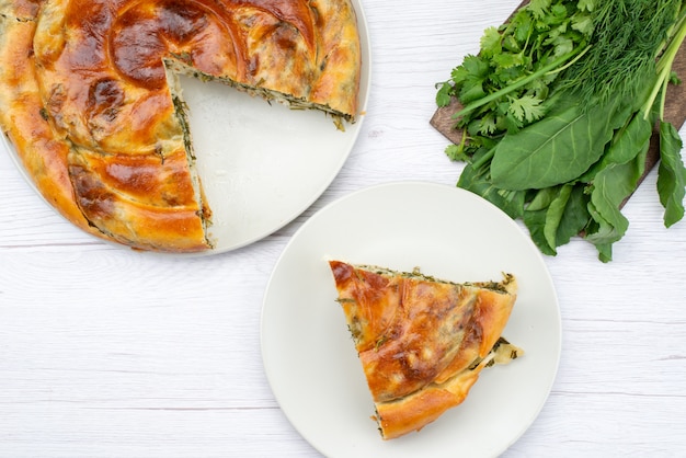 Top view pastry with greens cooked along with fresh greens on the white desk food meal dinner photo