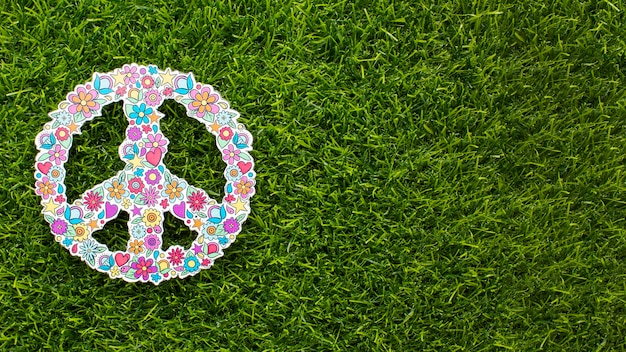 Free photo top view of peace sign on grass with copy space