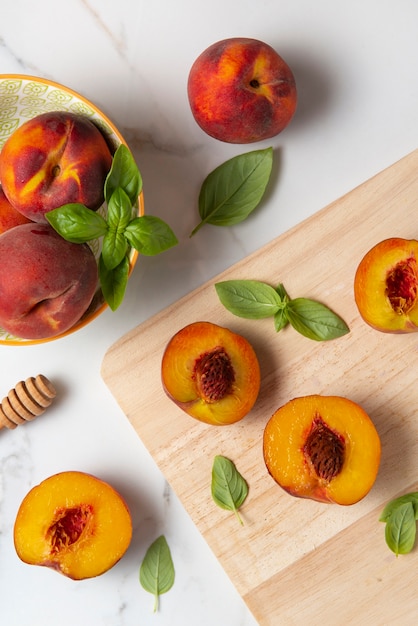 Free Photo top view peaches on wooden board