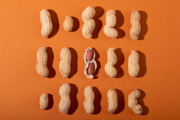 Top view peanuts on orange background