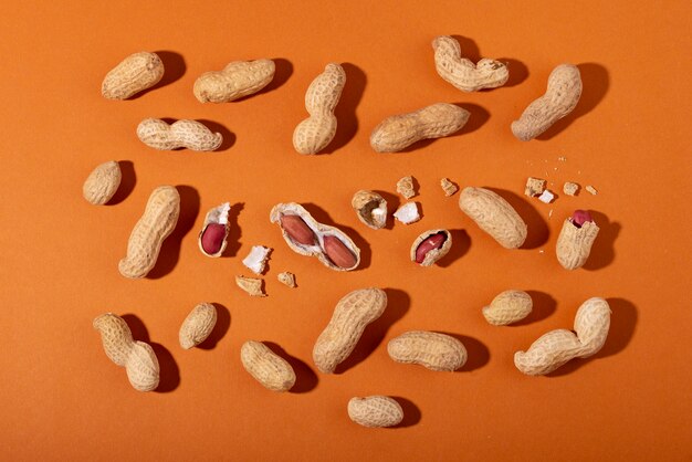 Top view peanuts on orange background