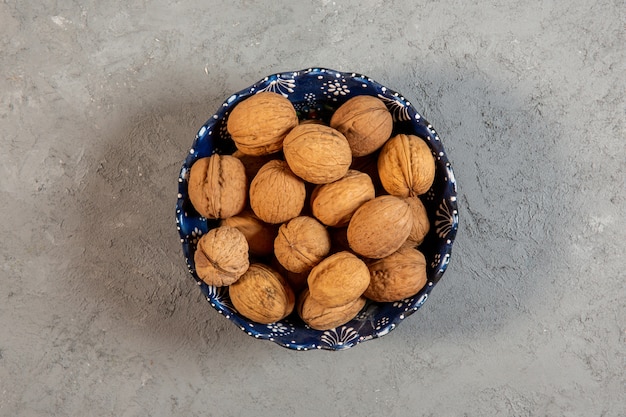 Free Photo top view not peeled walnuts in a vase