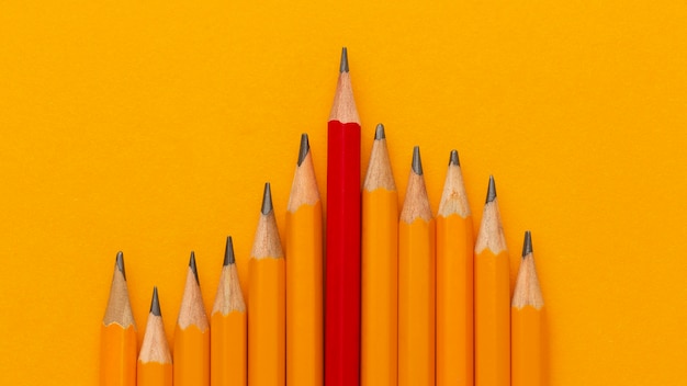 Free photo top view pencils on orange background