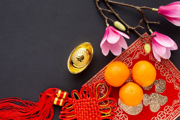 Free Photo top view of pendant and tangerines chinese new year