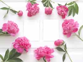 Free photo top view of peony flower frame with clear white paper