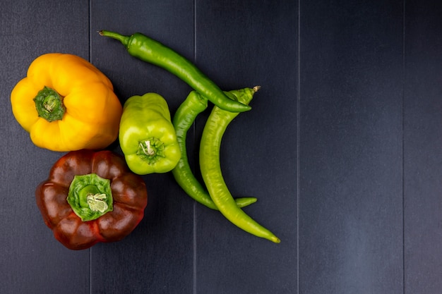 Free photo top view of peppers on black surface