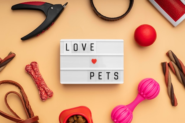 Free Photo top view on pet accessories still life concept with love pets text