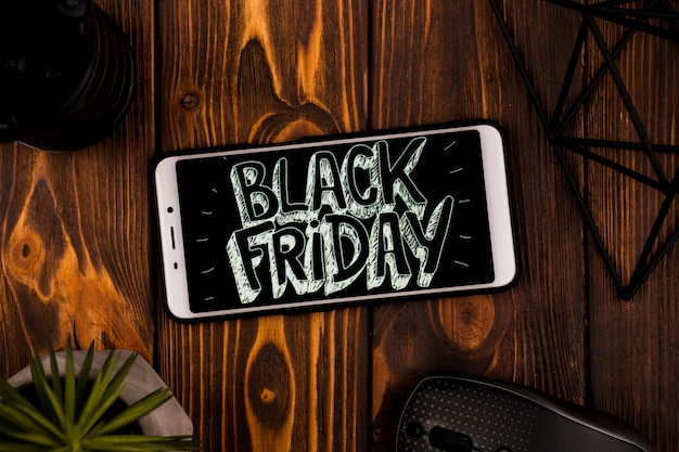 Free photo top view of phone with black friday message