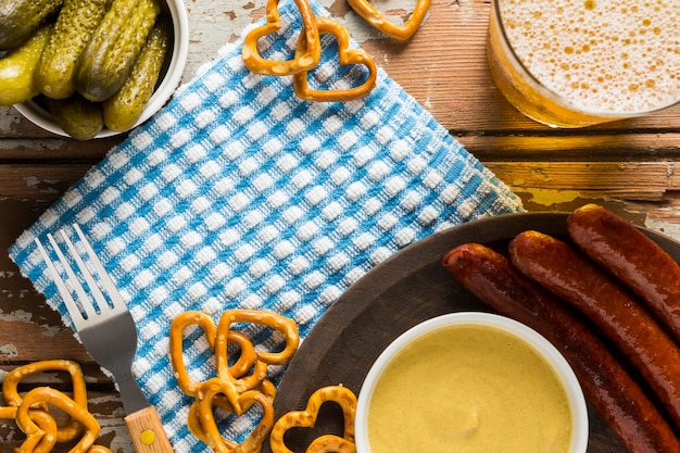 Top view of pickles with sausages and beer