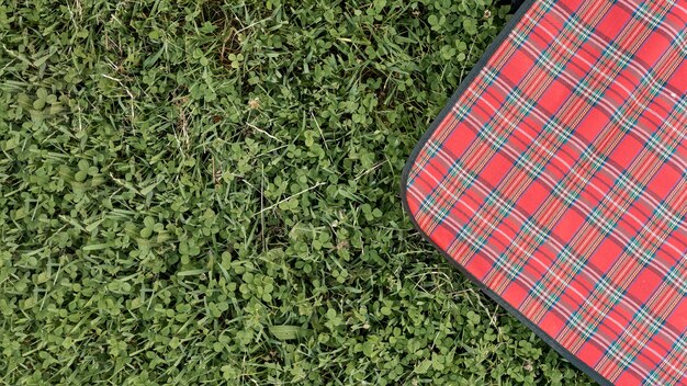 Top view picnic blanket on park grass