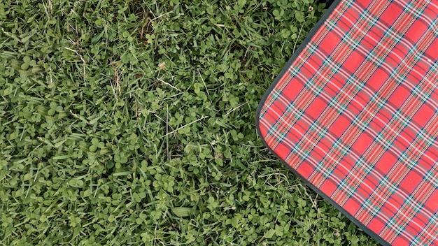 Top view picnic blanket on park grass