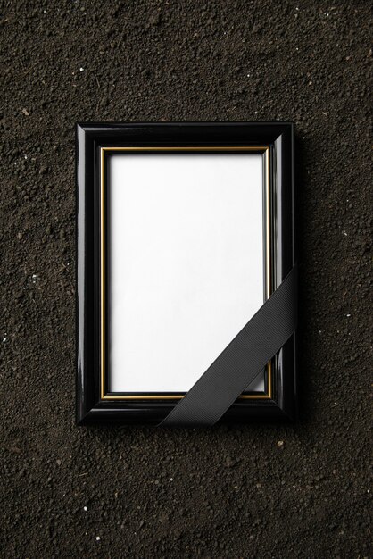 Top view of picture frame on the dark soil