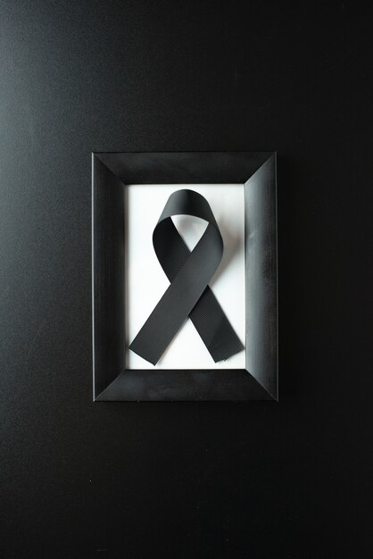 Top view of picture frame with black bow on dark wall