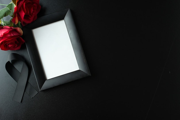 Top view of picture frame with black bow on dark wall