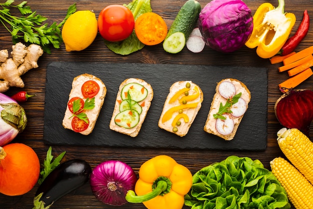 Free photo top view pieces of bread with veggies and vegetable arrangement