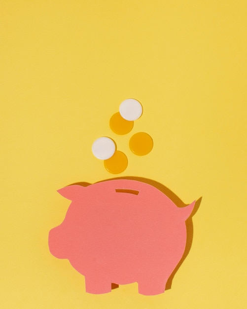 Free Photo top view piggy bank on yellow background