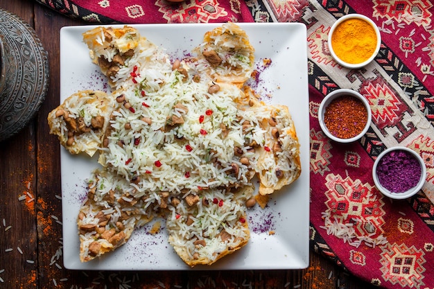 Free Photo top view pilaf in a pita with meat, beans and spices. traditional oriental dish on a dark wooden surface horizontal