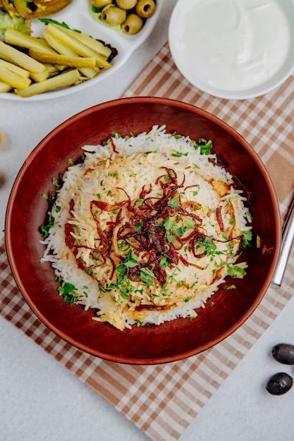 Top view of pilaf with beans and fried onions