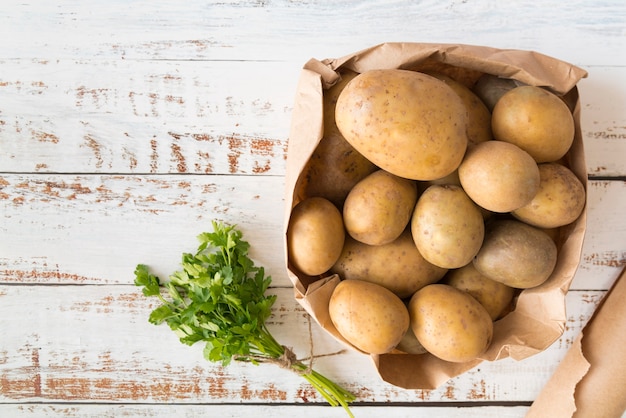 Top view pile of potatoes in paper bag