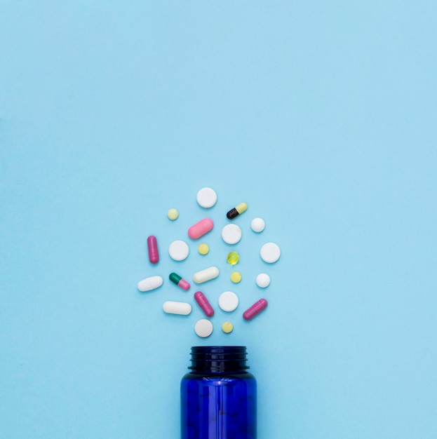 Top view of pills with container and copy space