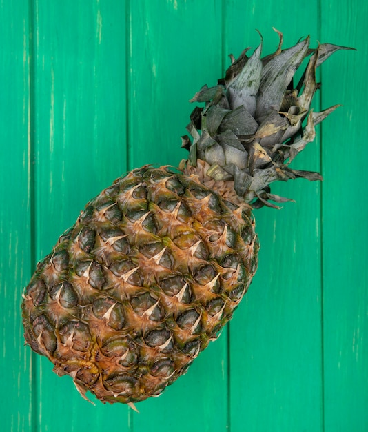 Top view of pineapple on green surface