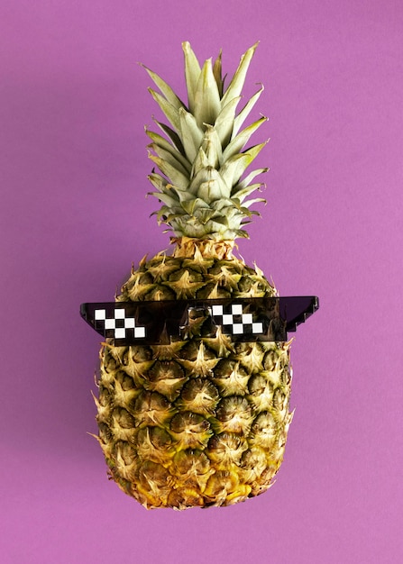 Free photo top view pineapple wearing glasses