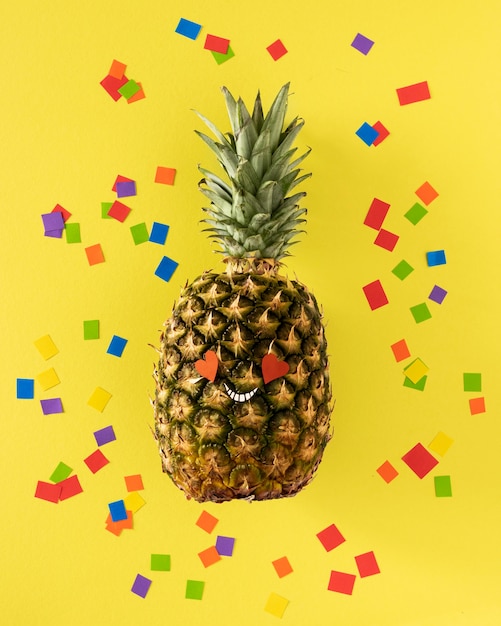 Free Photo top view pineapple with confetti